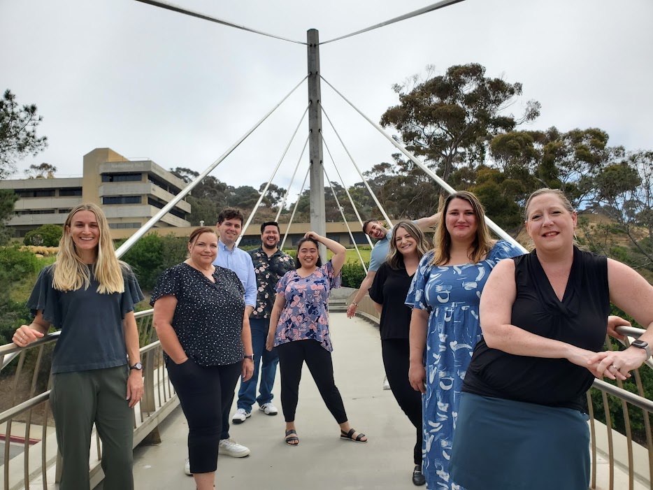A group photo of our Advising team standing on a bridge.